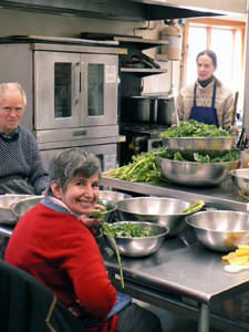 Robert and Linda work together to prepare a meal for the community.