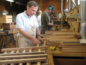 Willie works in the woodshop to create items for sale